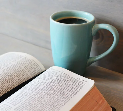 Blue Enamel Mug in Front of Notebook